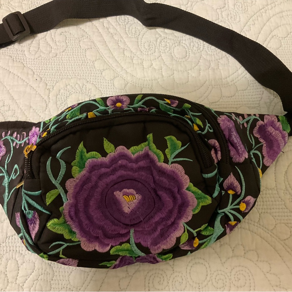 Fanny pack with three compartments, very roomy.  Purple embroidered flowers